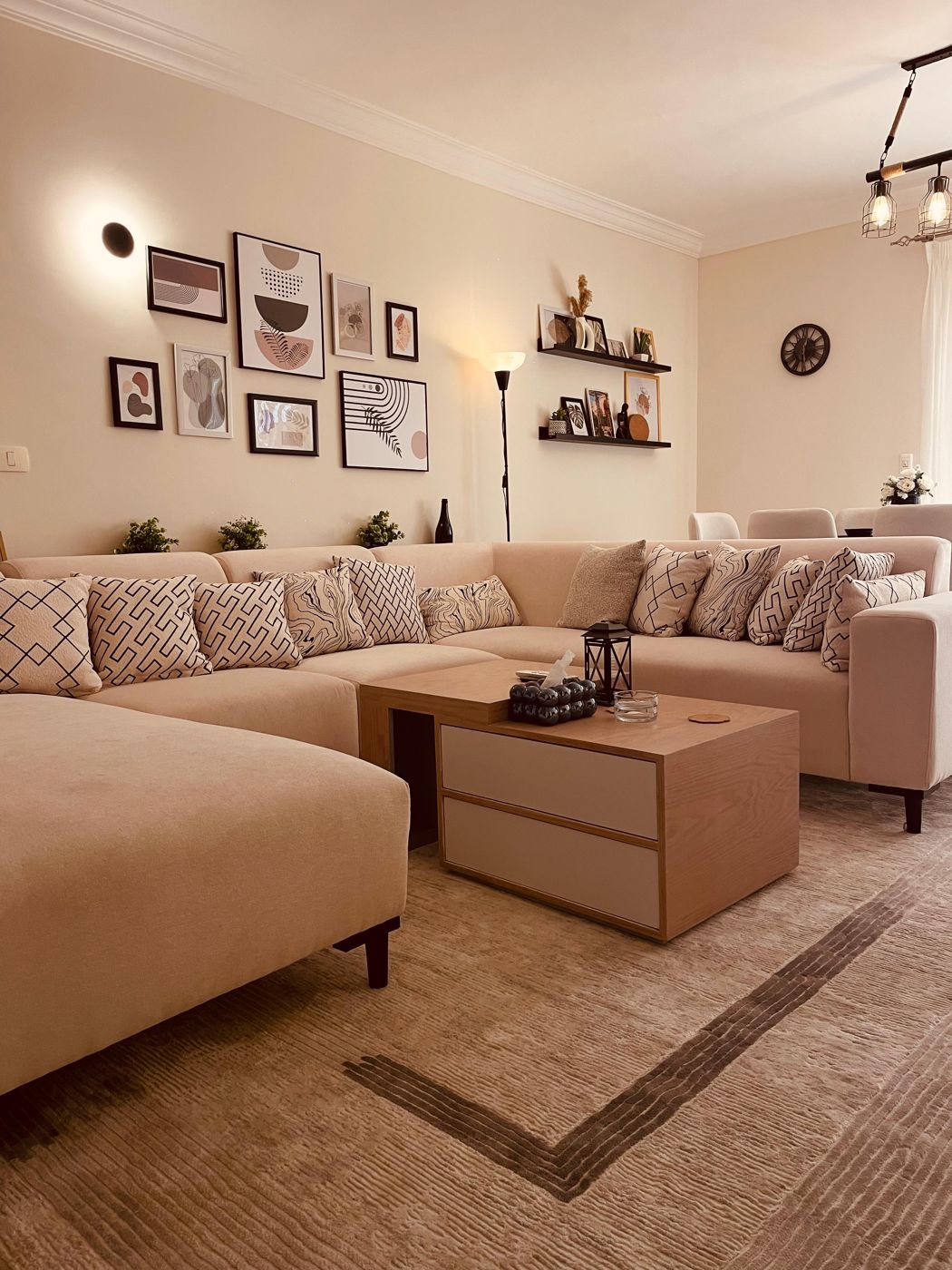 Garden View Residence living room with L-shaped sofa and gallery wall